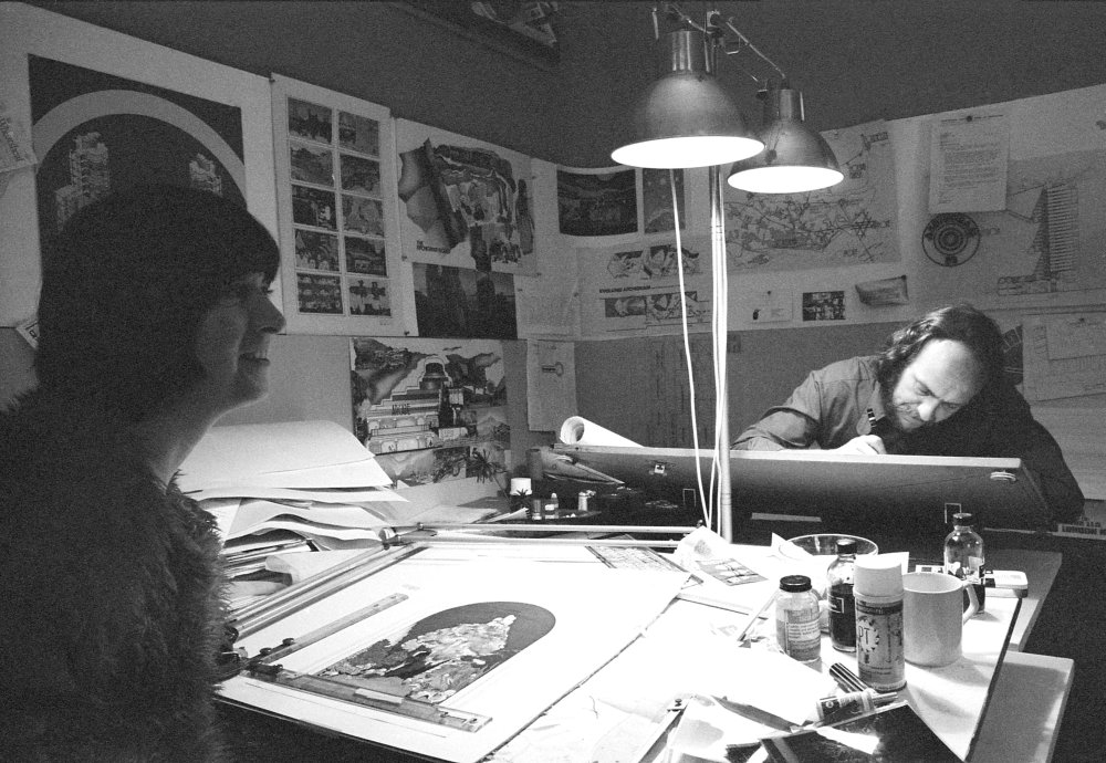 Archigram office, 53 Endell Street, Covent Garden, London: Archigram member Ron Herron at his drawing board with Hazel Cook, wife of Peter Cook, opposite. Photographer: Kathy de Witt. Image Date: 1972